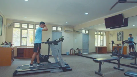 Man Walking Using Treadmill In Small Gym Room Stock Footage 162034431