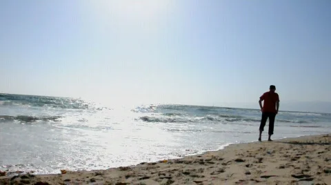 Man walking on Venice Beach, Los Angeles, at sunset Stock Footage 815853