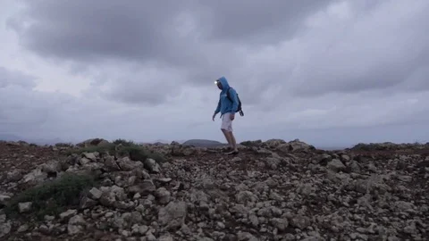 Man walking on volcanic landscape Stock Footage 71551997