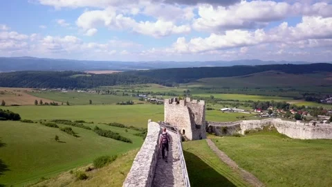 Man walking on the wall of Spis Castle, Slovakia Stock Footage 311493459