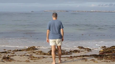 Man walking in water in beach Video stock 116734029