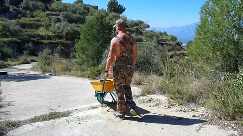 Man walking with the wheelbarrow Stock Footage 154634490