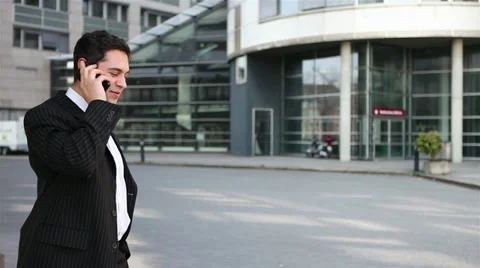 Man walking while talking on phone Stock Footage 11292117