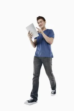 Man walking while using digital tablet Foto stock