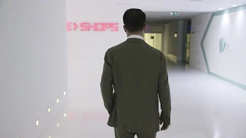 Man walking on a white corridor 스톡 동영상 142352205
