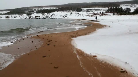 Man walking on winter ocean beach steadicam shot Stock Footage 34092468