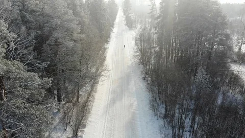 Man walking on a winter road Stock Footage 101899966