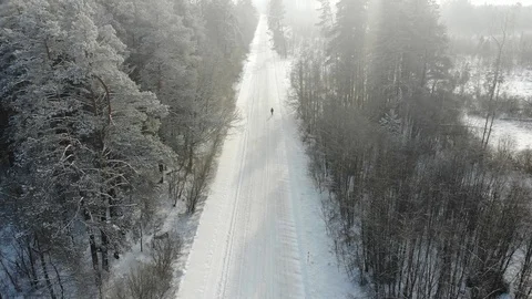 Man walking on a winter road Stock Footage 101900077