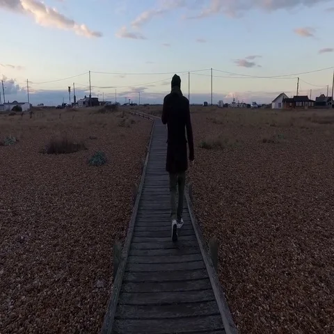 Man walking on a wooden path Stock Footage 69505274