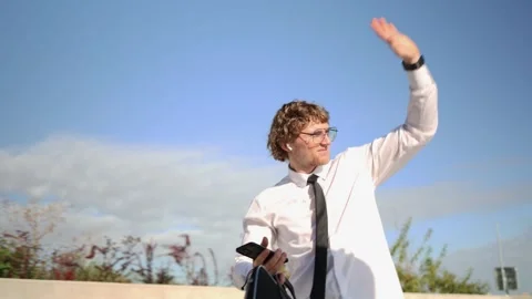 Man walking to work and waving hello to people during morning commute Video stock 346362917