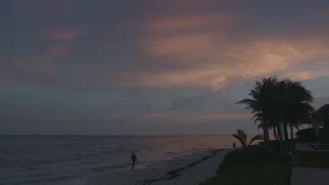 Man Walks Alone on Beach In Mexico at Sunset Stock Footage 229338930