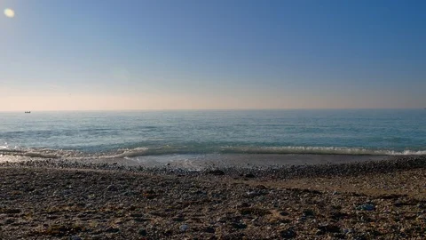 Man walks alone pebbled beach Stock-Footage 97009978