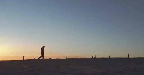 A man walks alone at sunset Stock Footage 157102500