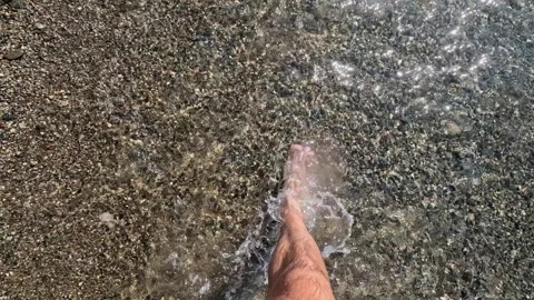 A man walks along the beach. First-person view. Video stock 256327524