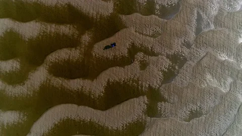 A man walks along the bottom of a shallow river. Video stock 145718963