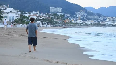 Man walks along ocean beach. Stock Footage 10787694