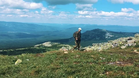 A man walks along the path to the mountains. Stock Footage 94245990