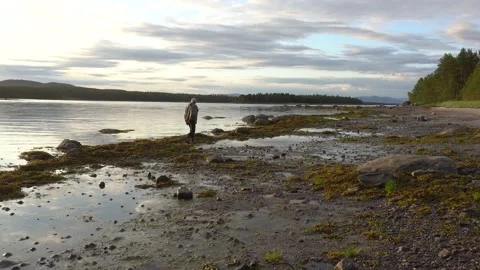A man walks along the seashore Stock Footage 152373875