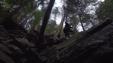 Man Walks Along the Top of a Waterfall Stock Footage 79736588