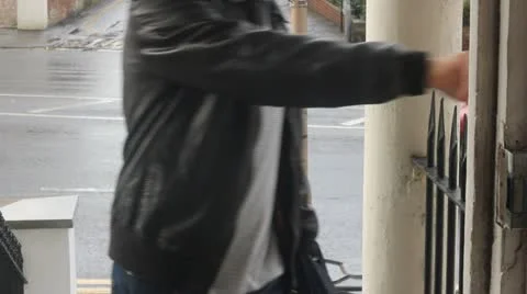Man walks into apartment from the rain Stock Footage 10897487