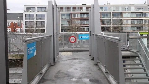 A man walks away from camera over a little bridge Video stock 112559221