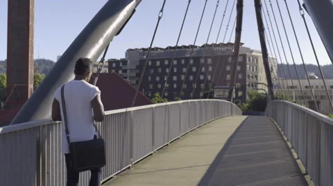 Man Walks (Away From Camera) On Pedestrian Bridge In City Video stock 67884662
