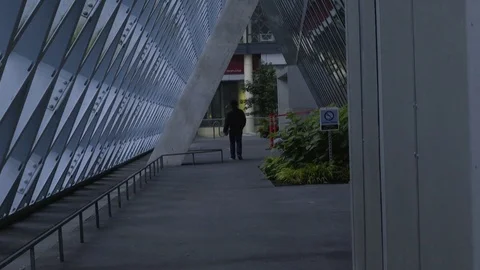 Man walks away from camera at Seattle public library Stock Footage 73491345