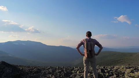 A man walks with a backpack on the background of a beautiful mountain landscape. Stock Footage 135188837