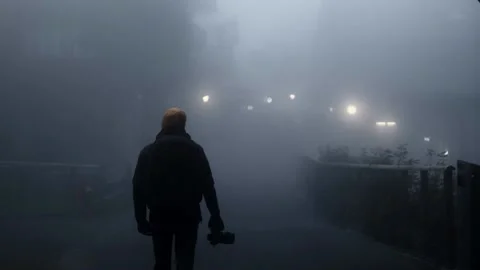 A man walks with backpack in a thick fog. Video stock 201165059