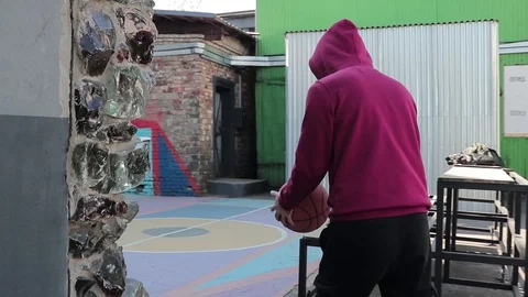 A man walks with a basketball Video stock 129041728