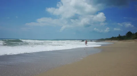 Man walks on beach 2 Stock Footage 32300501