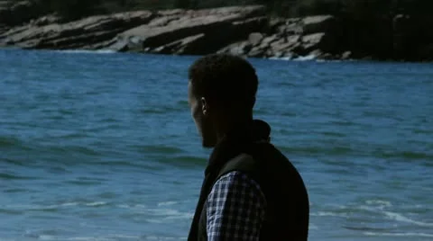 Man Walks on Beach Video stock 11060770