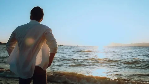 Man walks on the beach Stock Footage