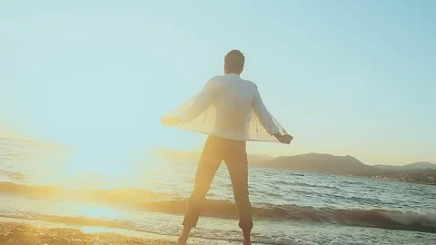 Man walks on the beach Stock Footage 81056356