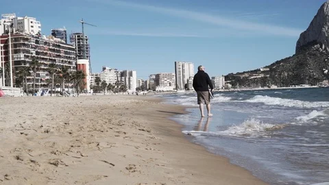 Man walks the beach Stock Footage 89684626