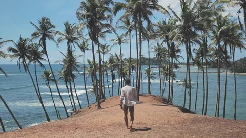 Man walks on beach island Stock Footage 109422331