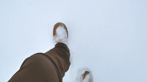 Man walks in big winter boots steps on clean untouched white snow 库存影片 99174853