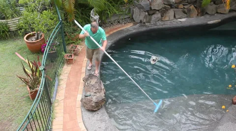 Man Walks Cleaning Pool Stock Footage 34499762