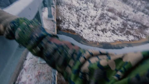 A man walks dangerously along the edge of a bridge in winter. Stock Footage 321645340