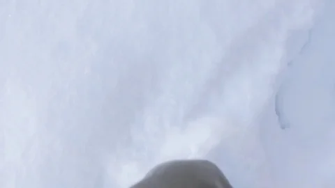 Man walks in deep snow in winter, feet view from above, looking down Video stock 72317282
