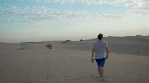 Man walks into the desert Stock Footage 134356174