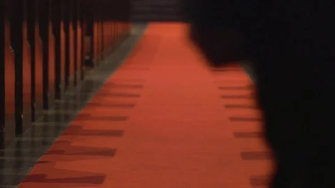 Man walks down aisle between church pews, low shot Stock Footage 85167464