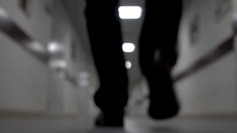 A man walks down the corridor. Blurred background. Young man walking down the Stock Footage 104766176