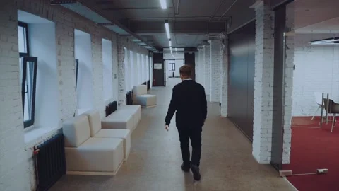 A man walks down the corridor, the camera follows the man on the steadica Stock Footage 166910415