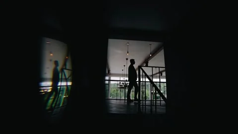 A man walks down a dark corridor. His silhouette is visible Stock Footage 263967907