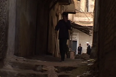 Man walks down dark narrow street towards camera. Stock Footage 86753338