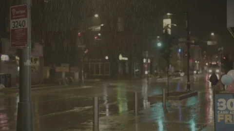 Man walks down empty main road at night in rainy town - Soft focus on rain Stock-Footage 270255038