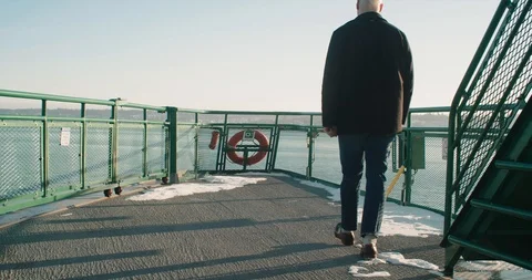 Man walks down ferry deck to take in view of Puget Sound in Washington Stock Footage 102463658