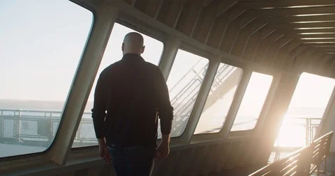 Man walks down ferry deck to take in view of Puget Sound in Washington Stock Footage 102467080