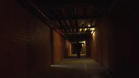 Man Walks Down Long Creepy Hallway Video stock 72296029